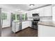 Modern kitchen with white cabinets, stainless steel appliances, granite countertops and tiled backsplash at 969 Oak Sw St, Atlanta, GA 30310