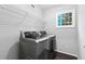Gray laundry room showcasing a modern washer and dryer under a wire shelf at 969 Oak Sw St, Atlanta, GA 30310