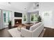 Bright living room with a fireplace, hardwood floors, and an abundance of natural light from large windows at 969 Oak Sw St, Atlanta, GA 30310