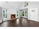 Inviting living room featuring a brick fireplace, hardwood floors, and large windows that provide ample light at 969 Oak Sw St, Atlanta, GA 30310