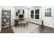 Home office featuring dark hardwood floors, neutral colored walls, with a simple desk, shelves and a chair at 969 Oak Sw St, Atlanta, GA 30310
