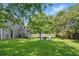 Expansive backyard showcasing a fire pit area with chairs and mature trees, enhancing privacy at 1501 Jamerson Landing, Marietta, GA 30066
