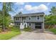 Charming two-story home with gray siding, white trim, landscaped yard, and attached one-car garage at 1501 Jamerson Landing, Marietta, GA 30066