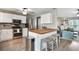 Modern kitchen with white cabinets, stainless steel appliances, a wood-topped kitchen island, and a breakfast bar at 1501 Jamerson Landing, Marietta, GA 30066