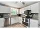 Well-lit kitchen featuring white cabinets, stainless steel appliances, and granite countertops at 1501 Jamerson Landing, Marietta, GA 30066