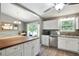 Bright kitchen with white cabinets, granite countertops, stainless steel appliances, and a breakfast area at 1501 Jamerson Landing, Marietta, GA 30066