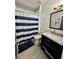 Modern bathroom featuring shiplap, sleek vanity, and stylish fixtures at 1782 Telfair Chase Way, Lawrenceville, GA 30043