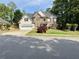 Charming two-story home featuring stone and shingle siding, well-manicured lawn, and attached two-car garage at 1782 Telfair Chase Way, Lawrenceville, GA 30043