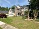 Charming two-story home featuring stone and shingle siding, well-manicured lawn, and an attached two-car garage at 1782 Telfair Chase Way, Lawrenceville, GA 30043