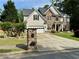 Charming two-story home featuring stone and shingle siding, well-manicured lawn, and long concrete driveway at 1782 Telfair Chase Way, Lawrenceville, GA 30043