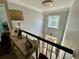 Bright foyer with chandelier, table with decor and pictures, and view of the front entrance at 1782 Telfair Chase Way, Lawrenceville, GA 30043
