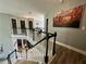 Second-floor hallway featuring hardwood floors, an art piece, and dark paneled doors at 1782 Telfair Chase Way, Lawrenceville, GA 30043
