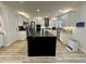 Bright kitchen features a large island with seating, stainless steel appliances, and white cabinets at 1782 Telfair Chase Way, Lawrenceville, GA 30043