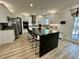 Bright kitchen features a large island with seating, stainless steel appliances, and white cabinets at 1782 Telfair Chase Way, Lawrenceville, GA 30043