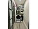 Modern laundry area with stacked washer/dryer units and efficient shelving at 1782 Telfair Chase Way, Lawrenceville, GA 30043