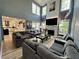 Open living room with fireplace, tall windows and luxury couches at 1782 Telfair Chase Way, Lawrenceville, GA 30043