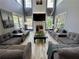Bright living room with high ceilings and large windows is furnished with comfortable sofas and decor at 1782 Telfair Chase Way, Lawrenceville, GA 30043