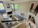 Aerial view from staircase overlooking living room with fireplace, large windows, and chandelier at 1782 Telfair Chase Way, Lawrenceville, GA 30043