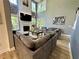 Bright living room with high ceilings and large windows is furnished with comfortable sofas and decor at 1782 Telfair Chase Way, Lawrenceville, GA 30043