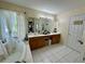 Main bathroom features double vanity, bathtub, bright natural light, and private toilet area at 1782 Telfair Chase Way, Lawrenceville, GA 30043