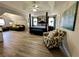 Spacious main bedroom featuring a seating area, four poster bed, and hardwood floors at 1782 Telfair Chase Way, Lawrenceville, GA 30043