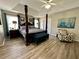 Comfortable main bedroom featuring four-poster bed, natural light, and ceiling fan at 1782 Telfair Chase Way, Lawrenceville, GA 30043