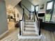 Bright foyer staircase with views to modern white kitchen, living room with fireplace, and large windows at 1782 Telfair Chase Way, Lawrenceville, GA 30043