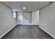 Basement area with gray walls, dark wood-look floors, and white doors at 2211 Rocky Mill Dr, Lawrenceville, GA 30044