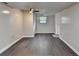 Basement area with gray walls, dark wood-look floors, and a ceiling fan at 2211 Rocky Mill Dr, Lawrenceville, GA 30044