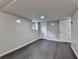 Basement area with gray walls, dark wood-look floors, and white doors at 2211 Rocky Mill Dr, Lawrenceville, GA 30044