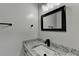 Clean and bright bathroom featuring granite countertop, black accents, and modern fixtures at 2211 Rocky Mill Dr, Lawrenceville, GA 30044