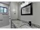Bathroom with a granite countertop, modern black faucet, and black framed mirror at 2211 Rocky Mill Dr, Lawrenceville, GA 30044