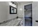 Bathroom with granite countertop, modern black faucet, and doorway leading to the bedroom at 2211 Rocky Mill Dr, Lawrenceville, GA 30044