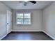 Bright bedroom featuring gray walls, dark wood-look floors, a window, and a ceiling fan at 2211 Rocky Mill Dr, Lawrenceville, GA 30044