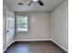 Bedroom featuring hard wood floors, a window, and a door leading to a closet at 2211 Rocky Mill Dr, Lawrenceville, GA 30044
