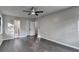This bedroom has gray wood flooring, a ceiling fan and doors to the bathroom and hallway at 2211 Rocky Mill Dr, Lawrenceville, GA 30044