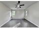 Spacious bedroom with hardwood floors, two windows, and a ceiling fan at 2211 Rocky Mill Dr, Lawrenceville, GA 30044