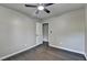 Bedroom featuring gray wood flooring, a ceiling fan, and an adjacent door at 2211 Rocky Mill Dr, Lawrenceville, GA 30044