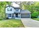 Charming two-story home with a well-manicured lawn and an attached two-car garage at 2211 Rocky Mill Dr, Lawrenceville, GA 30044