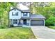 Charming two-story home with a well-manicured lawn and an attached two-car garage at 2211 Rocky Mill Dr, Lawrenceville, GA 30044