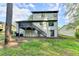 Rear exterior featuring a deck, stairs, and access to the basement level at 2211 Rocky Mill Dr, Lawrenceville, GA 30044