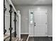 Bright foyer with hardwood floors, decorative staircase, and paneled front door at 2211 Rocky Mill Dr, Lawrenceville, GA 30044