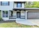 Inviting front entrance with a covered porch and a two-car garage at 2211 Rocky Mill Dr, Lawrenceville, GA 30044