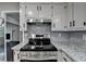 Modern kitchen equipped with stainless steel appliances, granite counters, and stylish cabinetry at 2211 Rocky Mill Dr, Lawrenceville, GA 30044