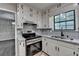 Bright kitchen featuring modern appliances, white cabinets, and a stylish backsplash at 2211 Rocky Mill Dr, Lawrenceville, GA 30044