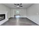 Spacious living room with a ceiling fan, fireplace, and hardwood flooring at 2211 Rocky Mill Dr, Lawrenceville, GA 30044