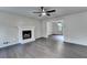 Spacious living room with a ceiling fan, fireplace, and hardwood flooring at 2211 Rocky Mill Dr, Lawrenceville, GA 30044