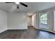 Bright living room with hardwood floors, a modern ceiling fan, and a large window overlooking the front yard at 2211 Rocky Mill Dr, Lawrenceville, GA 30044