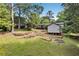 Expansive backyard featuring a shed, mature trees, and manicured lawn at 30 Dewey Se Ln, Marietta, GA 30060