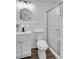 Modern bathroom featuring a glass shower, white vanity, and decorative mirror at 30 Dewey Se Ln, Marietta, GA 30060